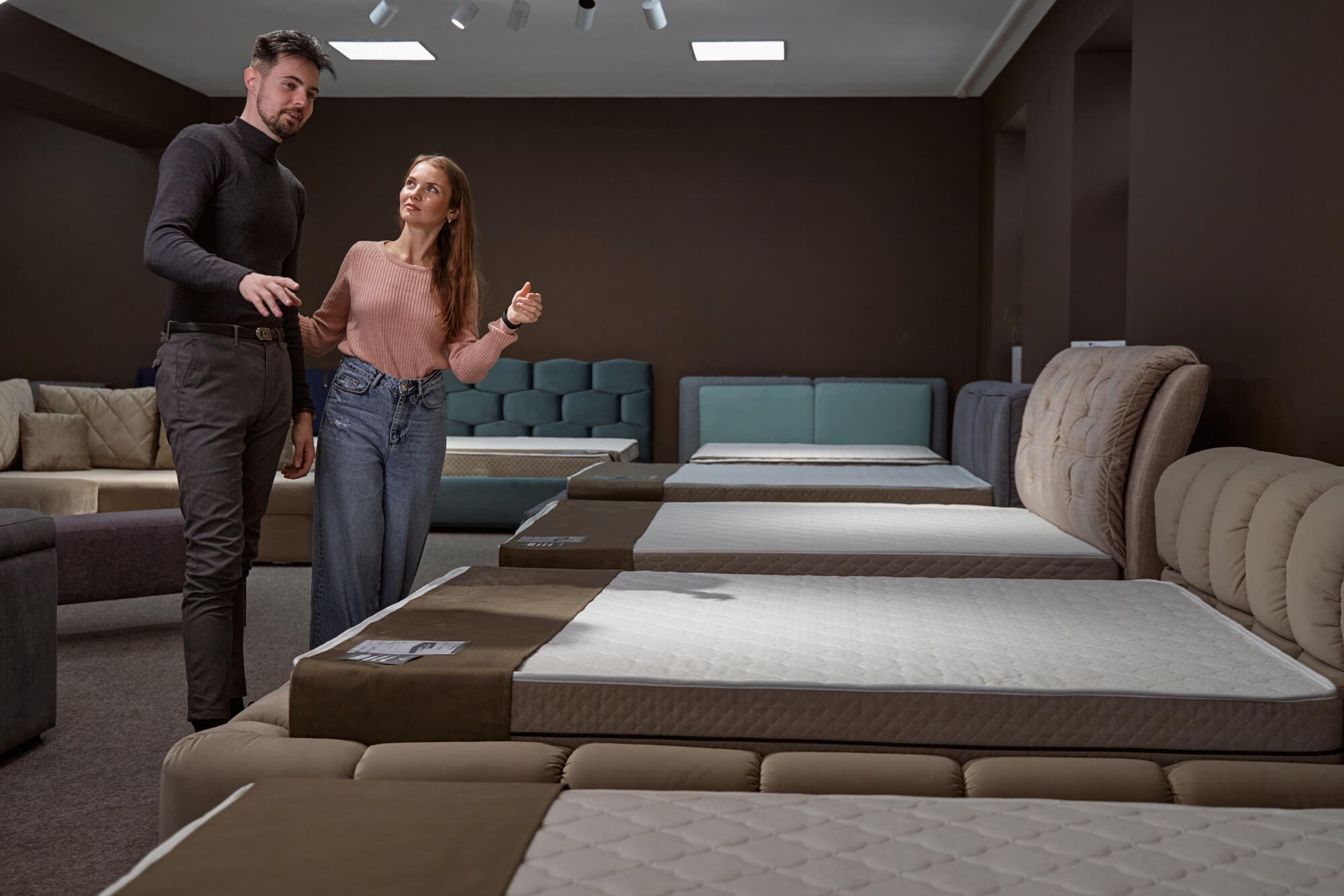 un couple qui regarde un matelas hybride